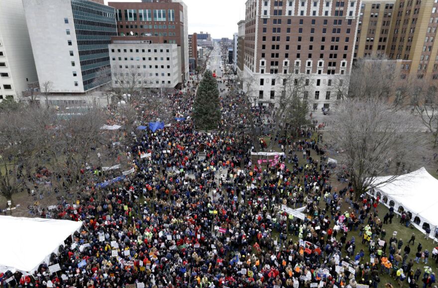Protesters gather for a rally outside the State Capitol in Lansing, Mich., Tuesday, Dec. 11, 2012. The crowd is protesting right-to-work legislation passed last week. Michigan could become the 24th state with a right-to-work law next week. Rules required a five-day wait before the House and Senate vote on each other's bills; lawmakers are scheduled to reconvene Tuesday and Gov. Snyder has pledged to sign the bills into law. (AP Photo/Paul Sancya)