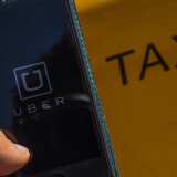 BARCELONA, SPAIN - JULY 01:  In this photo illustration, the new smart phone app 'Uber' logo is displayed on a mobile phone next to a taxi on July 1, 2014 in Barcelona, Spain. Taxi drivers in main cities strike over unlicensed car-halling services. Drivers say that is a lack of regulation behind the new app.  (Photo Illustration by David Ramos/Getty Images)