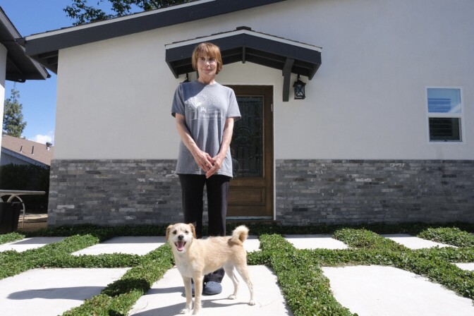Rose Liebermann stands in front of the accessory dwelling unit that allows her to live next to her adult daughter, now raising kids of her own.