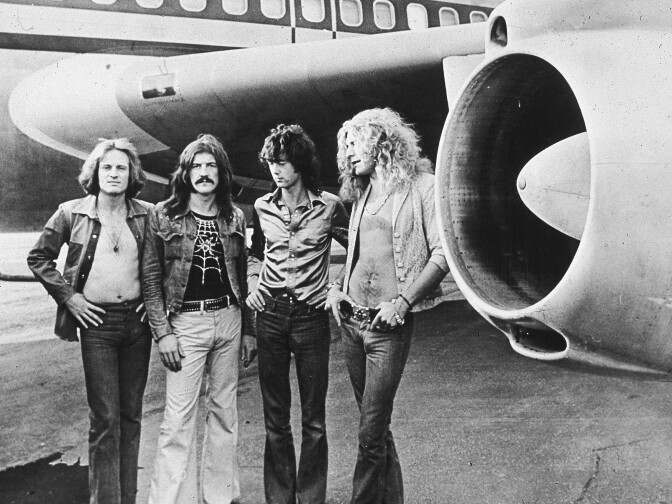 British rock band Led Zeppelin, (left - right): John Paul Jones, John Bonham (1948 - 1980), Jimmy Page and Robert Plant, pose in front of an their private airliner The Starship, 1973. (Photo by Hulton Archive/Getty Images)