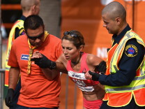 ASICS Elite Athlete Sara Hall is assisted by first aid after finishing the 2015 ASICS LA Marathon on March 15, 2015 in Los Angeles, California. 