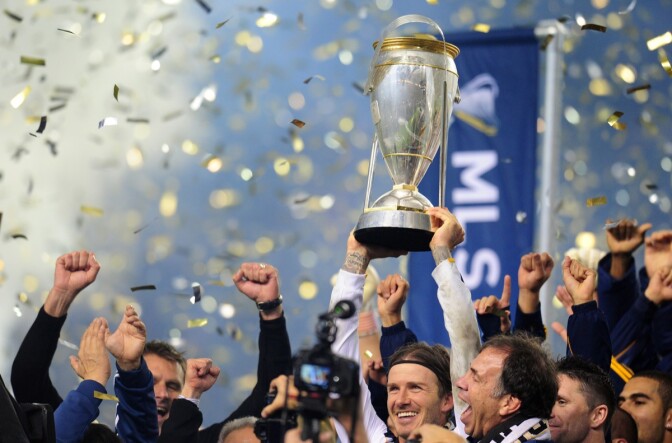 David Beckham of the LA Galaxy holds aloft the winning trophy following victory over the Houston Dynamo in their MLS Cup final at the Home Depot Center in Carson, California on November 20, 2011. The LA Galaxy defeated the Houston Dynamo 1-0.