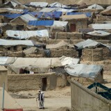 An Afghan man walks down a street next to the Nasaji Bagrami refugee camp in Kabul on April 18, 2012. Poverty and an ongoing insurgency by the ousted Taliban still pose a threat to the stability of the country. AFP PHOTO/ JOHANNES EISELE (Photo credit should read JOHANNES EISELE/AFP/Getty Images)