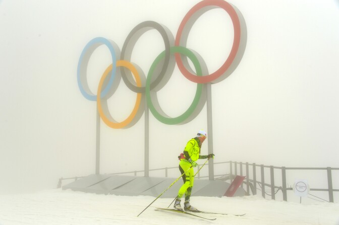 An athlete trains at the Laura Cross-Country Ski and Biathlon Center on February 17, 2014. Thick fog shrouding the mountains at the Sochi Olympics forced organizers to postpone events. Coaches at the Laura biathlon course said the biggest problem was not so much the fog as the poor quality of the snow.