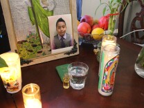 Candles and a picture of Jesse Romero, who was shot by police on Aug. 9.