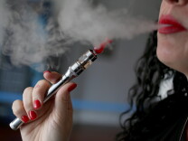 MIAMI, FL - FEBRUARY 20:  Julia Boyle enjoys an electronic cigarette at the Vapor Shark store on February 20, 2014 in Miami, Florida. As the popularity of E- cigarettes continue to grow, leading U.S. tobacco companies such as Altria Group Inc. the maker of Marlboro cigarettes are annoucing plans to launch their own e-cigarettes as they start to pose a small but growing competitive threat to traditional smokes.  (Photo by Joe Raedle/Getty Images)