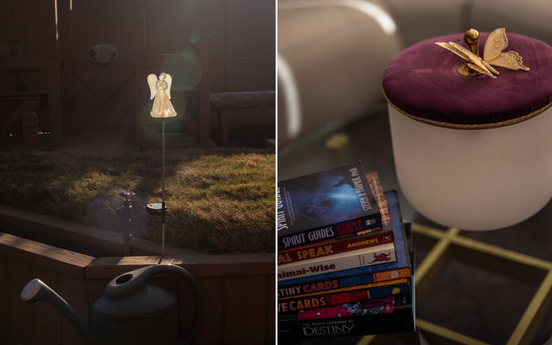 A yard ornament of an angel (left) glows in sunlight. At right a stack of books.