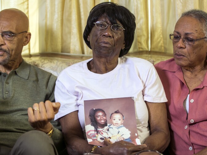 Earl Ofari Hutchinson, founder of the Los Angeles Urban Policy Roundtable, left,  Ada Moses, 91, the grandmother of Alesia Thomas, who died in 2012 after allegedly being kicked by a Los Angeles Police Department  officer while handcuffed, holding a photo of her grand daughter, seen at left with little sister, and Lita Herron, a community activist, take questions from the media in Los Angeles on Friday, Oct. 11, 2013. Attorneys are demanding the LAPD release a video that authorities say shows an officer kicking Thomas repeatedly while she was handcuffed. LAPD Officer Mary O'Callaghan was charged has pleaded not guilty to felony assault under the color of authority for the 2012 confrontation with Thomas. A LA Superior Court judge said the video will not be released to the public.