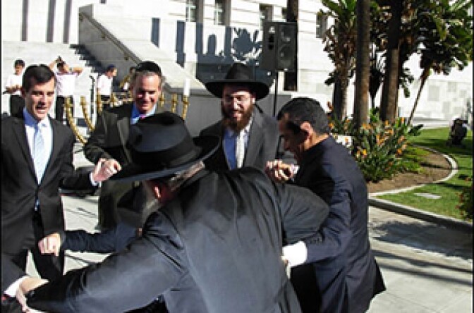 City Councilmen Garcetti and Weiss and Mayor Villaraigosa celebrate with rabbis from Chabad on the first day of Hanukkah. Behind them is the historic menorah that will stay in City Hall through the 8-day holiday. And behind it are members of the Jerusalem Children's Choir.