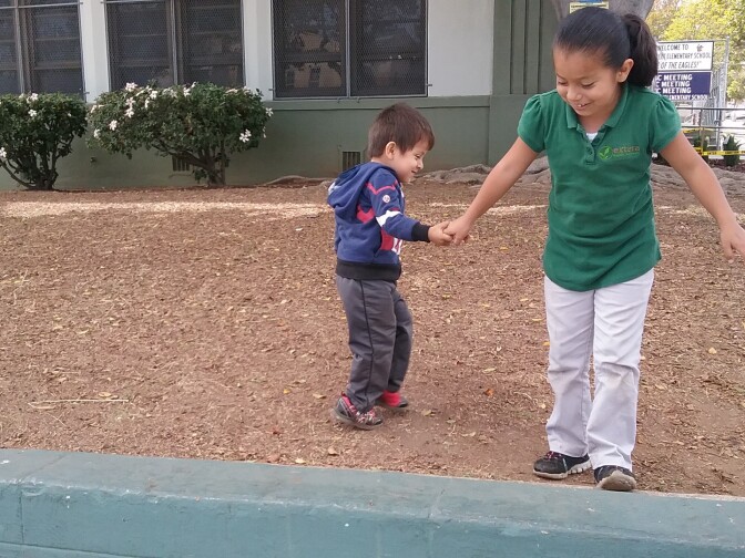 Siblings Alejandro, 3, and Emily, 7, often play on the outside lawn at Lorena Street School where Emily attends a Charter school. The pair live in an apartment with their parents so this is a play spot for them in the neighborhood. The Boyle Heights school is one of several that tested high for lead and the state is still deciding what to do about it.