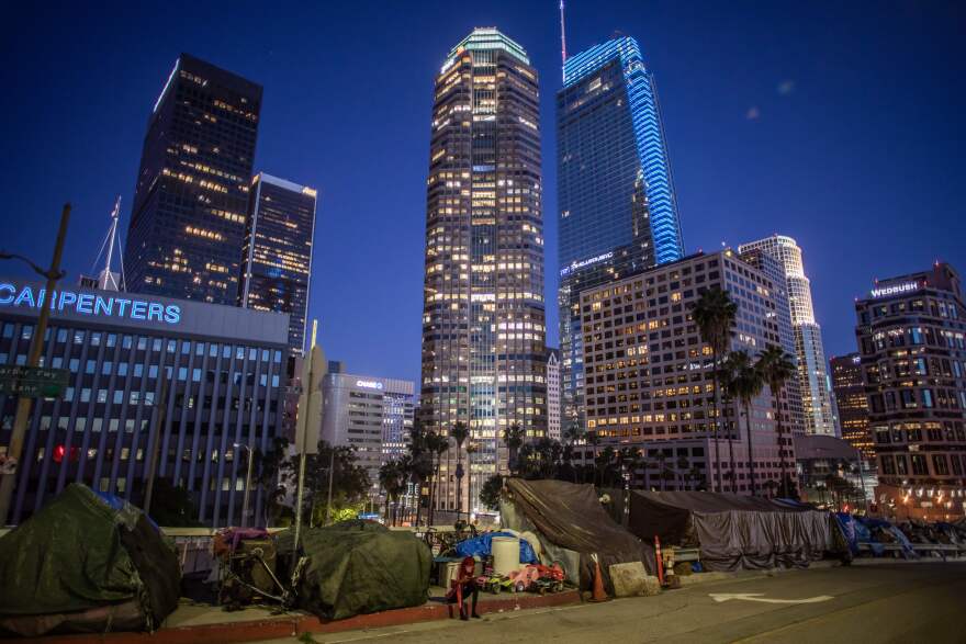 Tents in front of skyscrapers in Downtown Los Angeles.