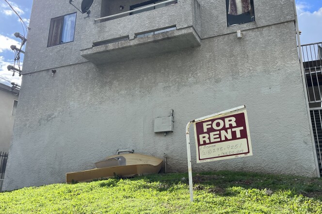 A "for rent" sign hangs near a discarded mattresses outside an apartment building in the city of Los Angeles. 