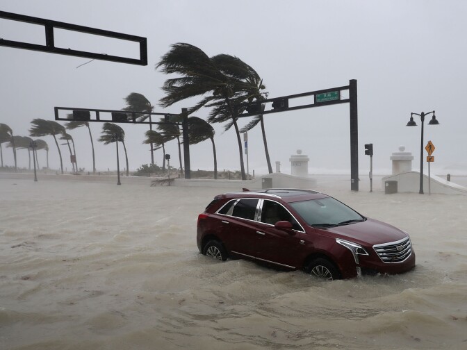 FORT LAUDERDALE, FL - SEPTEMBER 10:  A car sits abandoned in storm surge along North Fort Lauderdale Beach Boulevard as Hurricane Irma hits the southern part of the state September 10, 2017 in Fort Lauderdale, Florida. The powerful hurricane made landfall in the United States in the Florida Keys at 9:10 a.m. after raking across the north coast of Cuba.  (Photo by Chip Somodevilla/Getty Images)