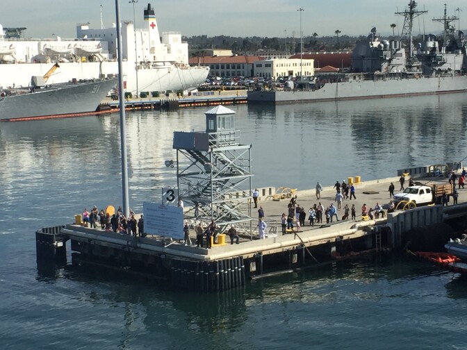 Family members gather at the end of Pier 4 at Naval Station San Diego as their loved ones onboard USS Decatur leave on deployment.