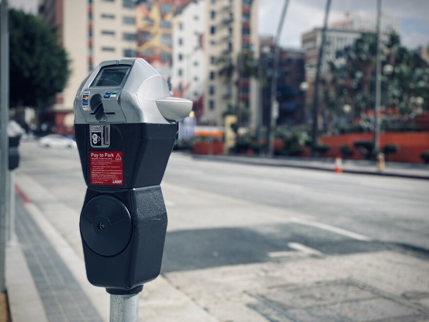 A parking meter that takes coins, credit and debit cards has instructions on a red sticker marked LADOT