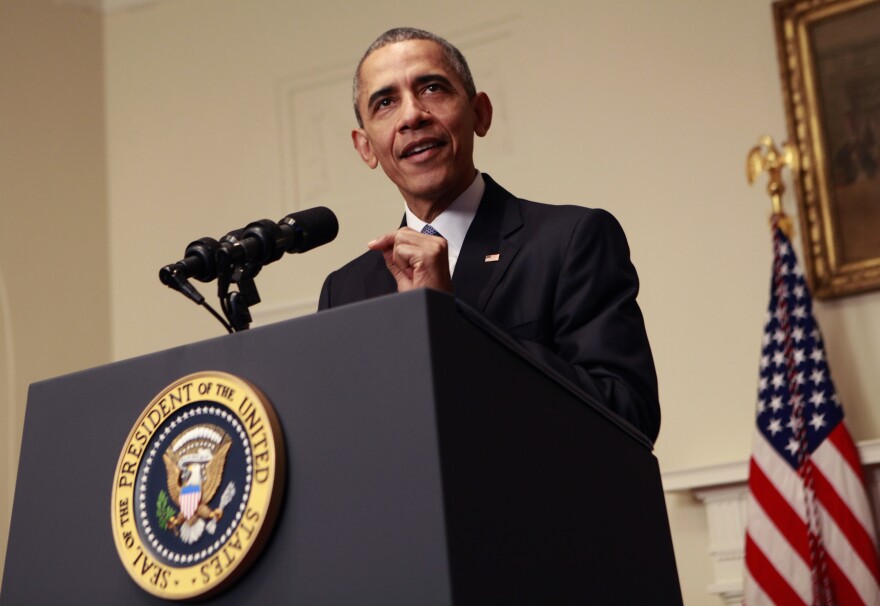 President Barack Obama makes a statement on the climate agreement in the Cabinet Room of the White House on December 12, 2015 in Washington, DC.  