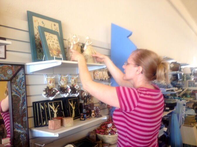 Kim Perez was setting up a holiday display at Ten Thousand Villages when she saw a $60 scarf she couldn't resist. She ended up buying the scarf for herself as a Christmas present.