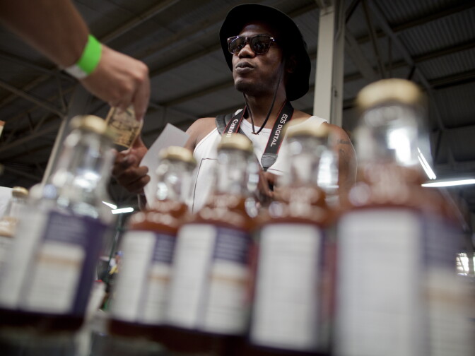 Dhane Crowley purchases a pot-infused tea drink made by the company Home Grown at the California Heritage Market in Boyle Heights. Crowley is working on a project called Plants and Palm Trees to increase public awareness about the medical benefits of cannabis and to demystify the culture surrounding the medicine, he said.