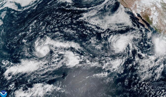 A satellite image of three tropical cyclones forming in the Pacific.
