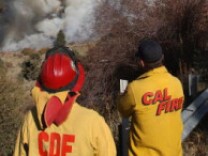 Firefighters for Cal Fire watch for hot spots. If a pension rollback deal is accepted, new firefighter hires would have to wait 5 years longer to retire. 