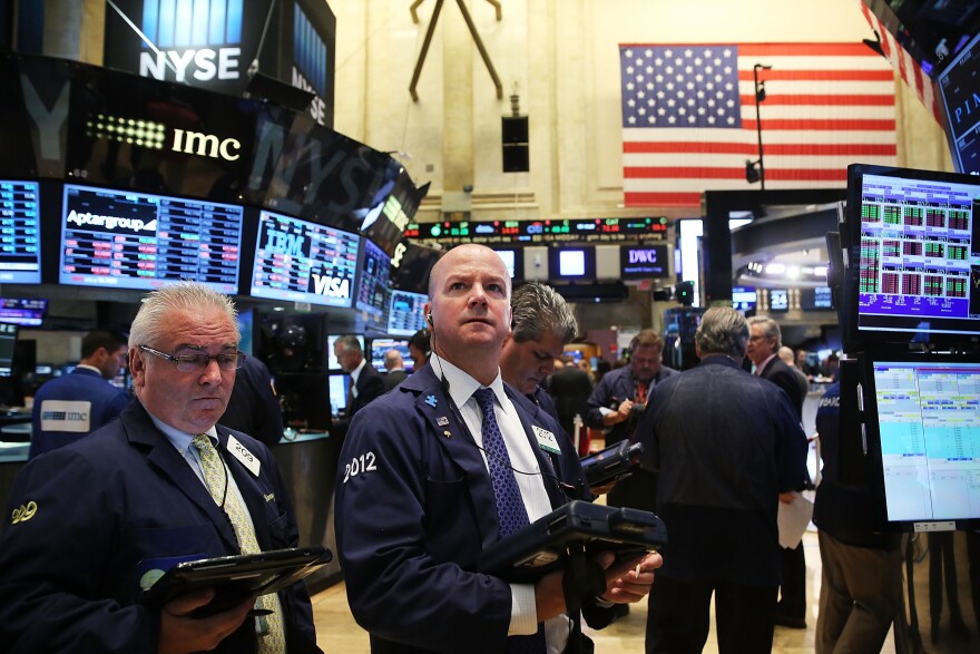 Traders work on the floor of the New York Stock Exchange (NYSE) on August 24, 2015 in New York City. As the global economy continues to react from events in China, markets dropped significantly around the world on Monday. The Dow Jones industrial average briefly dropped over 1000 points in morning trading. 
