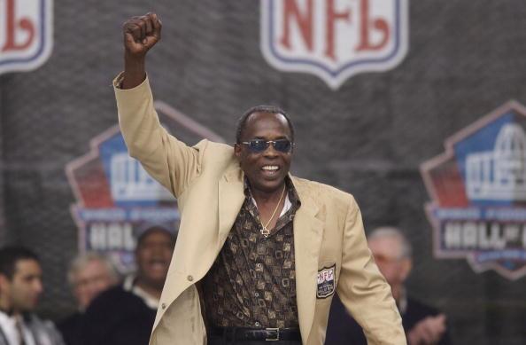 Pro Football Hall of Famer David "Deacon" Jones pumps his fist as he is introduced as part of the largest gathering of living Hall of Fame members during the 2003 NFL Hall of Fame Induction ceremony on August 3, 2003 in Canton, Ohio. Jones died Monday. He was 74. (Photo by David Maxwell/Getty Images)