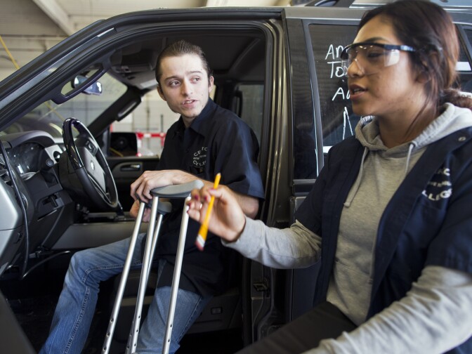 Students Michael Izaguirre, left, and Isabel Lazaro take part in a Ford break, steering and suspension class at Cerritos College on Wednesday, Feb. 11.