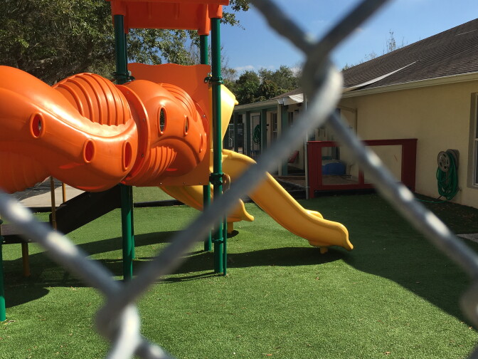 The play structure at La Estancia Head Start center is separated from the road by a chain link fence. If an immigration vehicle drives around the housing complex in which the center is situated, it would drive right by here. 