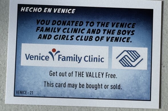 A card from a board game. It says: "You donated to the Venice Family Clinic and the Boys and Girls Club of Venice."