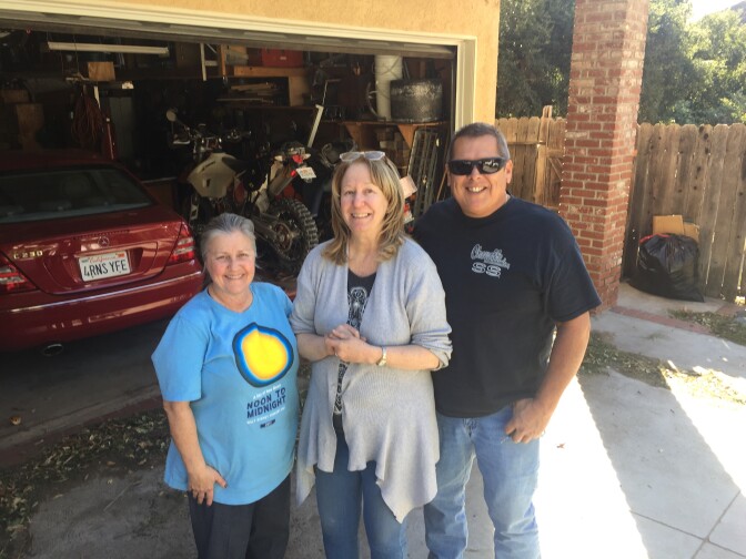 Carol Van Dusen (center) evacuated for the Creek Fire on Tuesday morning. She shared a moment of relief with her Kagel Canyon neighbors after returning to their homes on Friday.