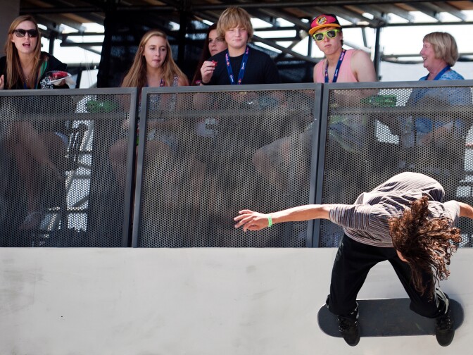 Attendees watch as skateboarder Evan Smith attempts a trick during the final round of the Men's Street league Skateboarding competition during the first day of X Games.