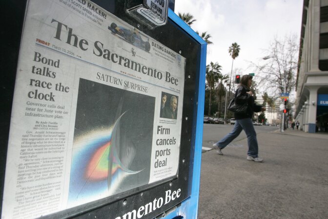 SACRAMENTO, CA - MARCH 10:  A woman walks by a Sacramento Bee newspaper rack March 10, 2006 in Sacramento, California. McClatchy Company, the publisher of the Sacramento Bee and other papers across the U.S. is said to lead bidding for Knight Ridder newspapers after bidding closed Tursday for the multi-billion dollar newspaper chain. Gannett Company, MediaNews Group Inc. and dozens of other papers have reportedly bid as well.  (Photo by Justin Sullivan/Getty Images)