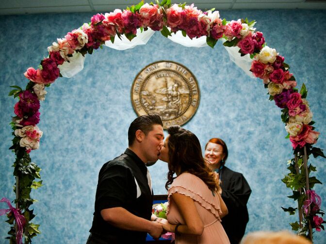 Rick and Jessica Garcia of West Covina kiss after they are married by volunteer  Elizabeth Oakes at the LA County Registrar-Recorder’s office on Monday in Norwalk. The couple have been together for two years.